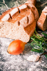 Fresh loaf of bread with onion and rosemary