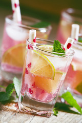 Pink cocktail with lime and mint, selective focus