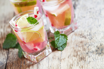 Pink cocktail with lime and mint, selective focus