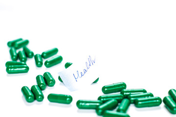 Medicine pills or capsules with inscription Health