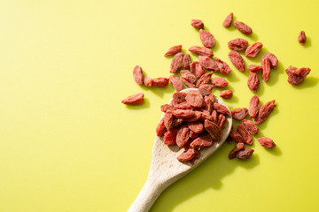 Goji berries on a wooden spoon