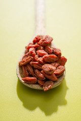 Goji berries on a wooden spoon