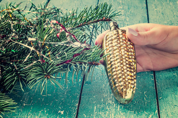 Old Christmas toys in the form of an ear of corn in a female hand. Selective focus. Tinted photos © 13smile