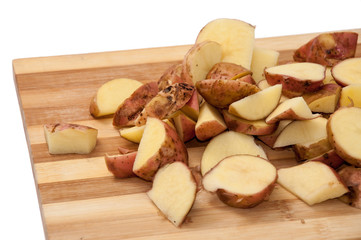 Sliced raw young potatoes on the wooden board