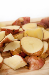 Sliced raw young potatoes on the wooden board
