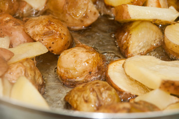 Frying young potatoes in deep hot oil