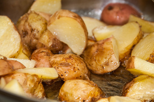 Frying young potatoes in deep hot oil