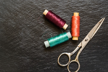 Old scissors and colorful silk thread