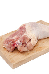 Chicken drumstick on the wooden board over white background