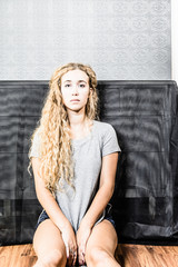 Fototapeta premium Cute American Female Sitting On Floor