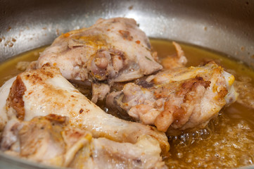 Frying chicken meat in deep hot oil