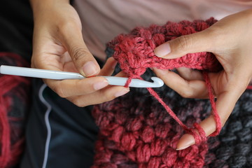 A girl showing how to crochet - obrazy, fototapety, plakaty