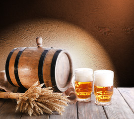 Beer barrel with beer glasses on table on brown background