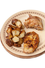 Fried young potatoes and chicken meat on the plate