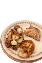 Fried young potatoes and chicken meat on the plate