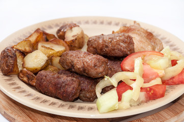 Young potaotes kebabs fried pork tomato salad paprika