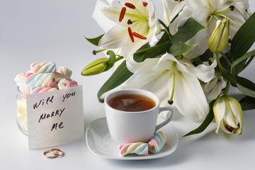 Cup of tea, white lily and note