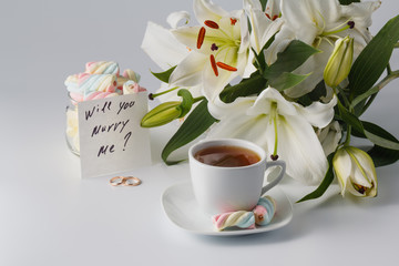 Breakfast concept. Cup of tea, white lily