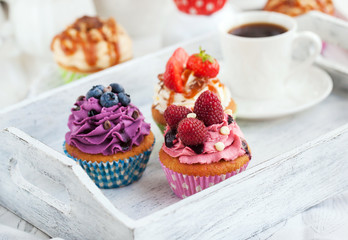 Different delicious cupcakes and coffee cup