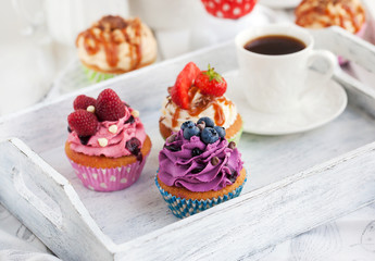 Different delicious cupcakes and coffee cup