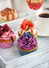 Different delicious cupcakes and coffee cup