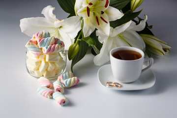 Cup of tea, white lily, colored marshmallow