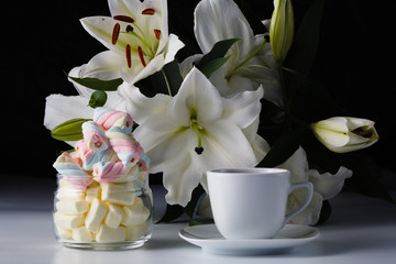 Morning cup of tea, white lily, colored marshmallow