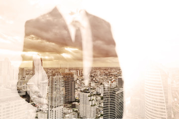 Double exposure of businessman and city