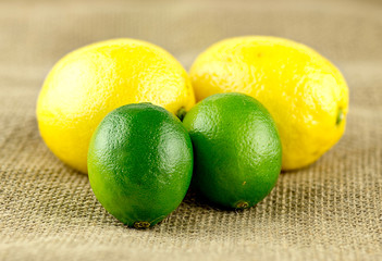 Lemon and limes on rustic background