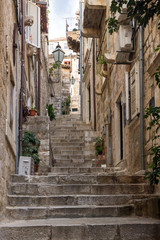 Fototapeta na wymiar Narrow and empty alley and stairs at the Old Town in Dubrovnik, Croatia.