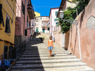 Young woman with sunglasses in Italian medieval town