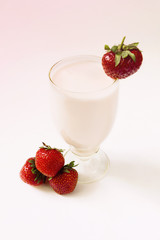 Strawberry yogurt in a glass with fresh strawberry on the table