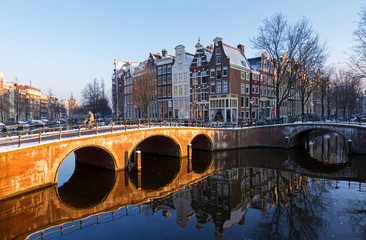Beautiful early morning winter view on one of the Unesco world heritage city canals of Amsterdam, The Netherlands. 