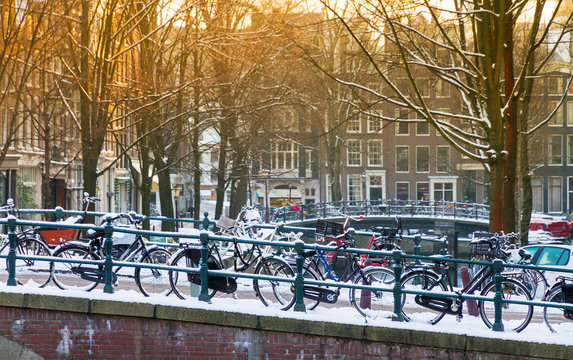 Bridge with bicycles in Amsterdam, the Netherlands, early in the morning in winter