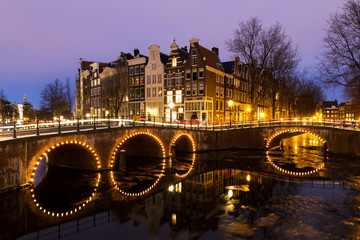 Beautiful view on the canals of Amsterdam, an Unesco world heritage site, in the Netherlands at twilight
