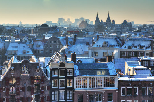 Winter skyline of Amsterdam, the Netherlands, with snow on the rooftops. Looking towards the south with the Rijksmuseum on the horizon