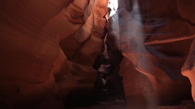 Sand Falling in Ray of Light in Antelope Canyon