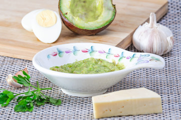 Avocado paste with egg, cheese and garlic