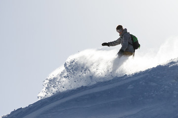 Snowboarder is having fun in the backcountry powder in the Italian Alps