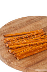 Salted sticks on wooden board