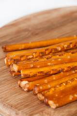 Salted sticks on wooden board
