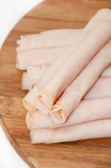 Naklejka premium Turkey breasts rolled on the wooden board
