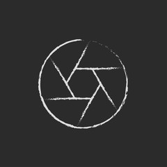 Camera shutter icon drawn in chalk.