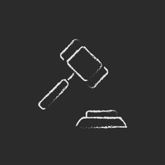 Auction gavel icon drawn in chalk.