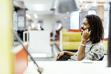 Handsome designer smiling while working in an office