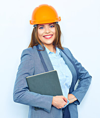 Toothy smiling business woman wearing a building helmet