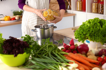 Young Woman Cooking in the kitchen. Healthy Food