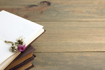 Dried flowers and book on wooden background