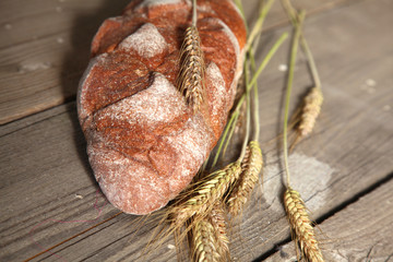 Freshly baked traditional bread on wooden table