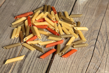 Raw homemade pasta and ingredients for pasta on wooden